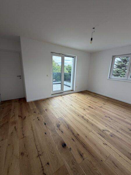 Schlafzimmer mit Ausgang auf Balkon im Haus 1